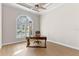Bright home office featuring a modern ceiling fan, hardwood floors, and a large window for lots of natural light at 15523 Trotting Horse Ln, Tavares, FL 32778