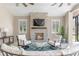 Inviting outdoor fireplace with stone surround and comfortable seating area at 15523 Trotting Horse Ln, Tavares, FL 32778