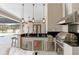 Outdoor kitchen with stainless steel appliances, granite countertops, and bar seating at 15523 Trotting Horse Ln, Tavares, FL 32778