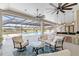 Expansive outdoor living area with a screened-in pool, kitchen, and comfortable seating at 15523 Trotting Horse Ln, Tavares, FL 32778