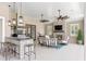 Outdoor living featuring a stone fireplace, full kitchen, bar seating, and comfortable furniture at 15523 Trotting Horse Ln, Tavares, FL 32778