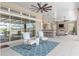 Spacious outdoor living space with fireplace, kitchen, and comfortable seating arrangement at 15523 Trotting Horse Ln, Tavares, FL 32778
