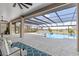 Expansive, screened-in pool area with plush seating and breathtaking water view at 15523 Trotting Horse Ln, Tavares, FL 32778