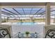 Tranquil, screened-in pool area with lounge chairs and a peaceful view at 15523 Trotting Horse Ln, Tavares, FL 32778