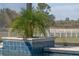 Close up on a pool detail with a lush green landscape and white fence at 15523 Trotting Horse Ln, Tavares, FL 32778