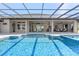 Gorgeous pool and patio area with an outdoor bar and lounge at 15523 Trotting Horse Ln, Tavares, FL 32778