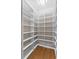 Spacious walk-in closet with custom shelving provides ample storage and organization at 15523 Trotting Horse Ln, Tavares, FL 32778