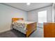 Comfortable bedroom featuring a bed, a dresser, a window, and neutral carpeting for a cozy ambiance at 1905 Snapper Dr, Kissimmee, FL 34759