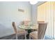 Dining room area with a glass table with seating for four and a large window at 1905 Snapper Dr, Kissimmee, FL 34759