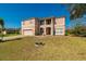 Charming two-story home with a spacious front yard, covered entryway, and attached two-car garage at 1905 Snapper Dr, Kissimmee, FL 34759