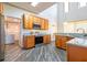 Kitchen featuring wood cabinets, stainless steel appliances, and granite countertops at 1905 Snapper Dr, Kissimmee, FL 34759