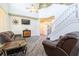 Living room featuring grey wood-look floors, leather furniture, and high ceilings at 1905 Snapper Dr, Kissimmee, FL 34759
