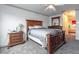 Spacious main bedroom with wood furniture, neutral walls, ceiling fan, and doorway to bathroom at 1905 Snapper Dr, Kissimmee, FL 34759