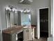 Primary bathroom with dual sinks, granite countertops, and a walk-in closet at 202 Shady Oaks Cir, Lake Mary, FL 32746