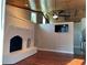 Inviting room with a painted brick fireplace, and hardwood floors at 202 Shady Oaks Cir, Lake Mary, FL 32746