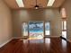 Bright living room with hardwood floors and French doors leading to a screened pool area at 202 Shady Oaks Cir, Lake Mary, FL 32746