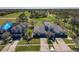 An aerial view of homes with manicured lawns with golf course in the distance on a sunny day at 20604 Maxim Pkwy, Orlando, FL 32833