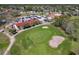 Aerial view of the golf course and clubhouse, featuring manicured greens and mature trees at 20604 Maxim Pkwy, Orlando, FL 32833