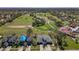 An aerial view of the property showing the residences and the nearby golf course, highlighting the community's amenities at 20604 Maxim Pkwy, Orlando, FL 32833