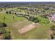 An aerial view of the golf course showcasing its manicured greens and surrounding landscape in the community at 20604 Maxim Pkwy, Orlando, FL 32833