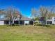 A serene backyard featuring a well-maintained lawn and mature trees, perfect for relaxation and outdoor activities at 20604 Maxim Pkwy, Orlando, FL 32833