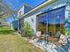 Outdoor patio area with seating, a grill, and a large sliding glass door leading to the home's interior at 20604 Maxim Pkwy, Orlando, FL 32833
