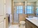 Bathroom highlighting a glass-enclosed shower, modern vanity, and neutral tile work at 20604 Maxim Pkwy, Orlando, FL 32833