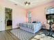 A cozy bedroom with pastel pink walls, king size bed, and adjacent bathroom access at 20604 Maxim Pkwy, Orlando, FL 32833
