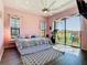 Bright bedroom with a king-size bed and sliding glass doors that offer outdoor views at 20604 Maxim Pkwy, Orlando, FL 32833