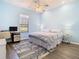 Bright bedroom with hardwood floors, a ceiling fan, and a comfortable bed with accent rugs at 20604 Maxim Pkwy, Orlando, FL 32833
