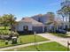 A charming home with a two-car garage and a neatly landscaped front yard, situated in a peaceful neighborhood at 20604 Maxim Pkwy, Orlando, FL 32833