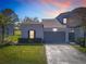 Charming home featuring a two-car garage, lush landscaping, and a well-manicured lawn in a desirable neighborhood at 20604 Maxim Pkwy, Orlando, FL 32833