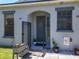 Inviting front entrance with an arched doorway, decorative plants, and a welcoming 'Dog Welcome' sign at 20604 Maxim Pkwy, Orlando, FL 32833