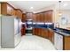 Well-lit kitchen with stainless steel appliances, wooden cabinetry, and sleek black countertops at 20604 Maxim Pkwy, Orlando, FL 32833