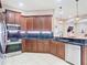 Kitchen showcasing stainless steel appliances, dark countertops, and custom wooden cabinets at 20604 Maxim Pkwy, Orlando, FL 32833