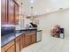 Open kitchen view showcasing stainless steel appliances, dark counters, and adjacent living area at 20604 Maxim Pkwy, Orlando, FL 32833