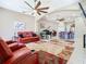 Spacious living room with a piano, comfortable seating, and an open floor plan at 20604 Maxim Pkwy, Orlando, FL 32833