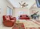 Spacious living room featuring comfortable seating, a grand piano, and large windows for natural light at 20604 Maxim Pkwy, Orlando, FL 32833