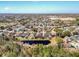 This aerial captures a peaceful pond surrounded by an established neighborhood with lush trees and well-kept residences at 2112 White Eagle St, Clermont, FL 34714