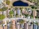 Overhead aerial view of a residential street, with a pond nearby, showcasing the community's layout and amenities at 2112 White Eagle St, Clermont, FL 34714