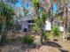 Home's backyard featuring a screened-in patio and lush landscaping at 2112 White Eagle St, Clermont, FL 34714