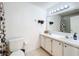 Bathroom with a double sink vanity, bright lighting, and tile flooring at 2112 White Eagle St, Clermont, FL 34714