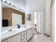 Bright bathroom features a double sink vanity with updated fixtures and a large mirror at 2112 White Eagle St, Clermont, FL 34714