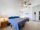 Well-lit bedroom features carpet, ceiling fan, and two bedside tables at 2112 White Eagle St, Clermont, FL 34714