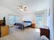 Bedroom features carpet, ceiling fan, and large windows for natural light at 2112 White Eagle St, Clermont, FL 34714