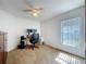 Cozy bedroom featuring a window, plush carpet, and a desk area for work or study at 2112 White Eagle St, Clermont, FL 34714