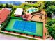 An aerial view reveals a pool and tennis court, surrounded by meticulously maintained landscaping at 2112 White Eagle St, Clermont, FL 34714