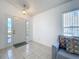 Bright foyer features tile flooring, neutral paint and front door with sidelight windows at 2112 White Eagle St, Clermont, FL 34714