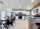 Bright kitchen with stainless steel appliances, white cabinets and bar seating at 2112 White Eagle St, Clermont, FL 34714