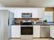 Bright kitchen with stainless steel appliances and white cabinets, offering a modern feel at 2112 White Eagle St, Clermont, FL 34714